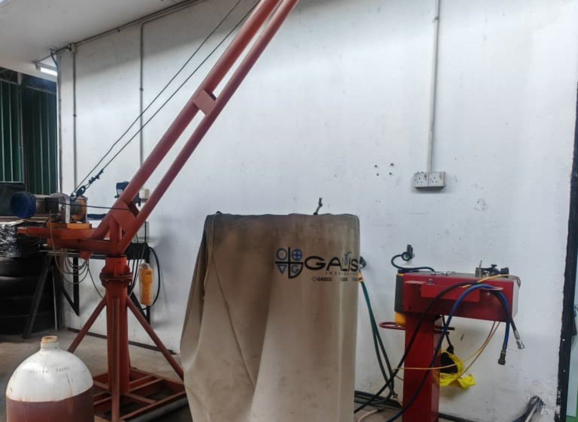 Cylinder being lifted by a crane in the workshop
